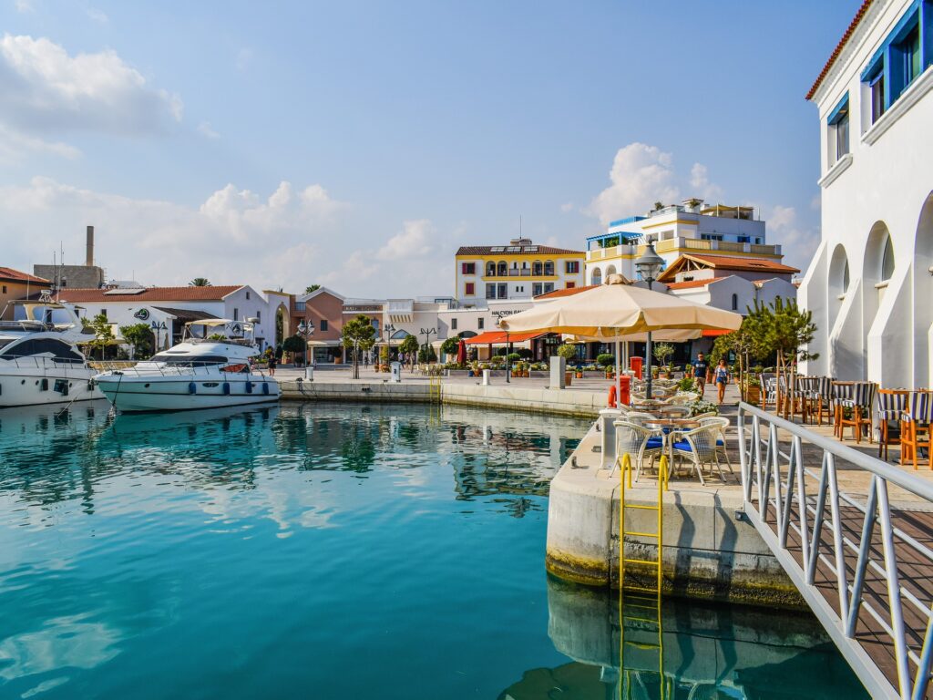 colourful port with boats parked and cafes around. Cyprus town.